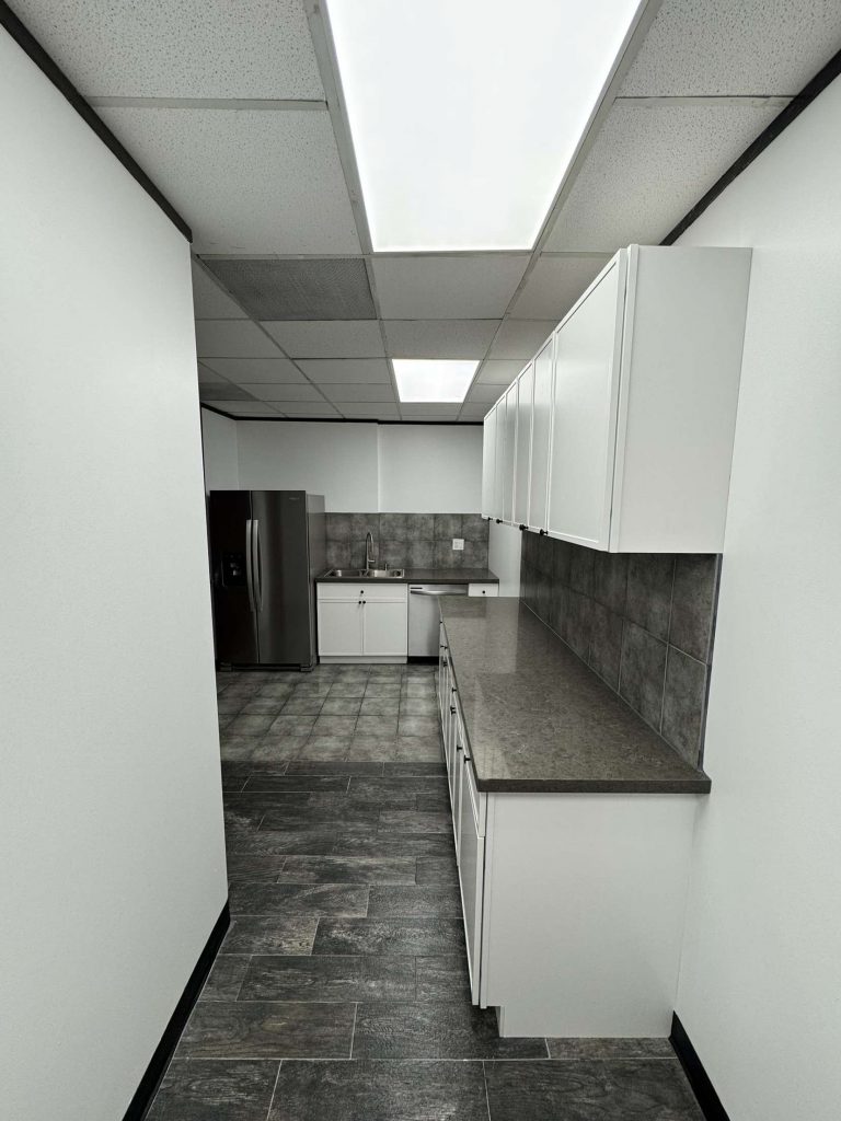 A modern commercial building break room and kitchen