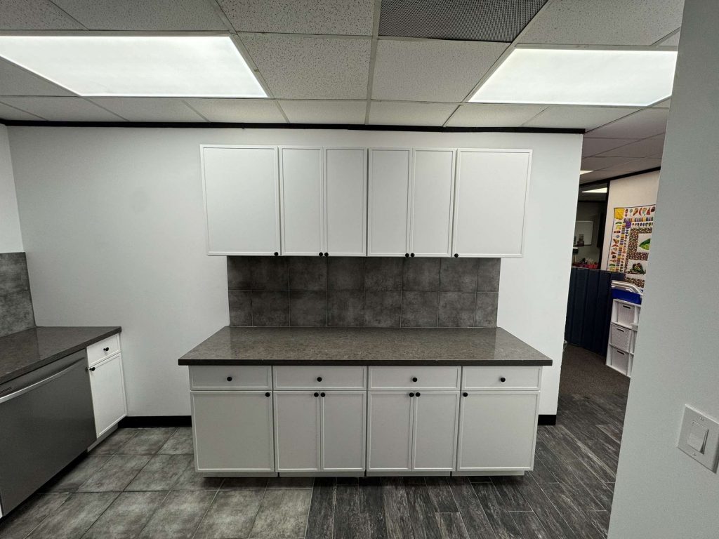 A modern commercial building break room and kitchen