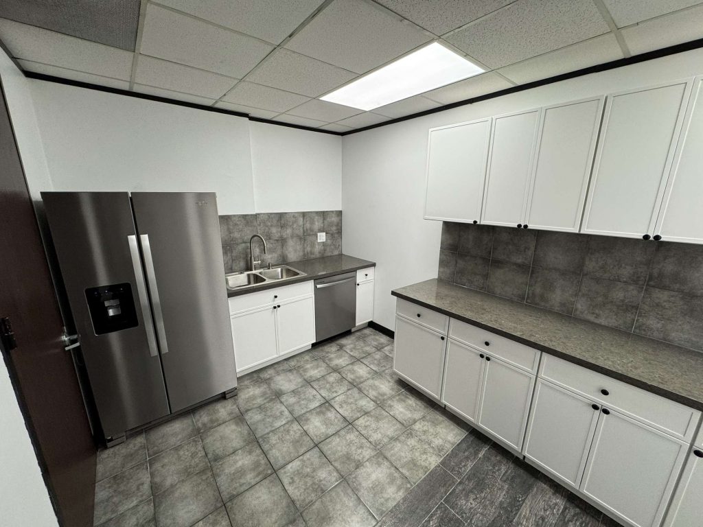 A modern commercial building break room and kitchen